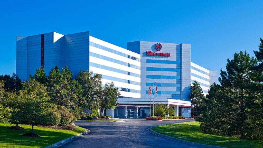 The exterior of the Sheraton Detroit Novi Hotel, viewed from the south, in the summer.